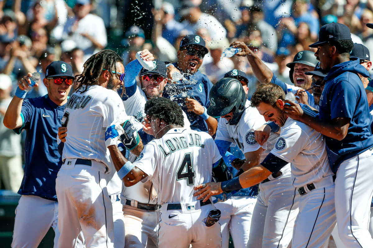 The Mariners celebrate Shed Long Jr.'s walk-off home run in the bottom of the 10th inning, which gave them a 6–2 win over the Rays at T-Mobile Park in Seattle on June 20, 2021.